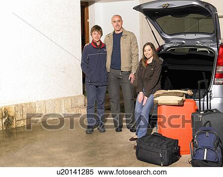 Father standing by car with son (11-13) and daughter (12-14) View Large Photo Image Stock Photography - Father standing by car with son (11-13) and daughter (12-14). Fotosearch