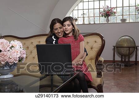 Girl (9-11) sitting on mothers lap using laptop View Large Photo Image Stock Image - Girl (9-11) sitting on mothers lap using laptop. Fotosearch