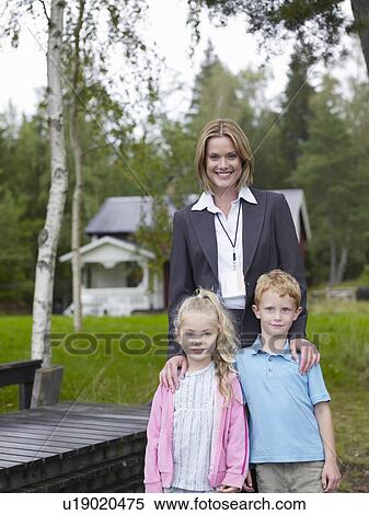 Stock Photography - Mother daughter and son in back yard. Fotosearch