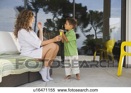 Woman and boy blowing bubbles. View Large Photo Image Stock Photography - Woman and boy blowing bubbles.. Fotosearch