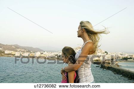 Woman and young girl looking over the water in Greece. View Large Photo Image Stock Image - Woman and young girl looking over the water in Greece.. Fotosearch