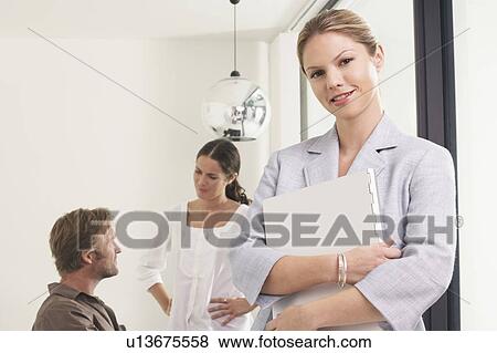 Man and two women in office woman in foreground with file. View Large Photo Image Stock Photo - Man and two women in office woman in foreground with file.. Fotosearch