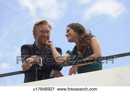 Young businessman and business woman on balcony. View Large Photo Image Stock Photo - Young businessman and business woman on balcony.. Fotosearch