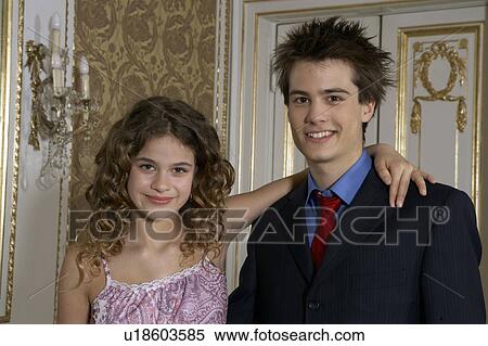 Stock Photography - Girl (9-11) and teenage boy (15-17) smiling, portrait. Fotosearch