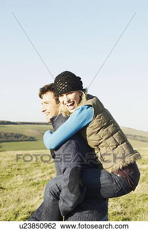 Man giving woman a piggyback View Large Photo Image Stock Image - Man giving woman a piggyback. Fotosearch