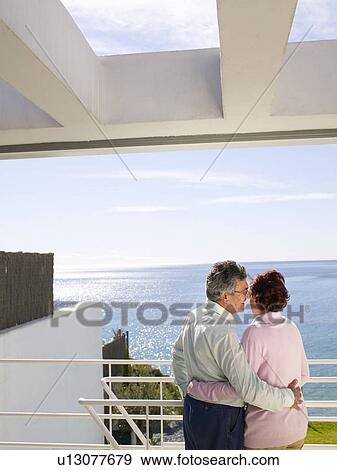 Mature couple looking out to sea View Large Photo Image Stock Photo - Mature couple looking out to sea. Fotosearch