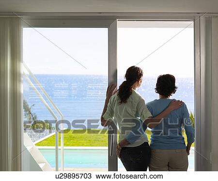 Mother and daughter looking out to sea View Large Photo Image Stock Image - Mother and daughter looking out to sea. Fotosearch