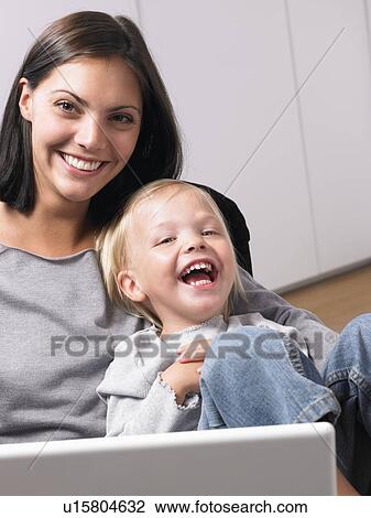 Stock Image - Mother and daughter smiling. Fotosearch