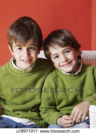 Two brothers (5-7) sitting together smiling, portrait View Large Photo Image Stock Photo - Two brothers (5-7) sitting together smiling, portrait. Fotosearch