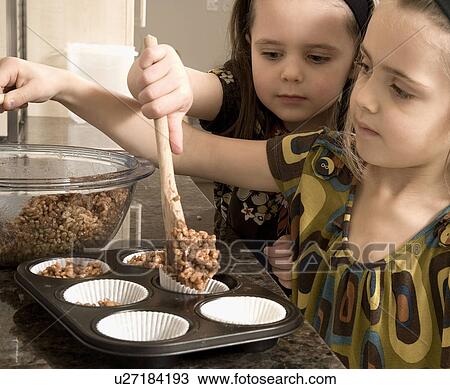 Young girls baking cakes View Large Photo Image Stock Image - Young girls baking cakes. Fotosearch