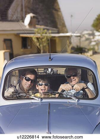 Boy (8-10) in sunglasses sitting in car with father and grandfather, portrait View Large Photo Image Picture - Boy (8-10) in sunglasses sitting in car with father and grandfather, portrait. Fotosearch