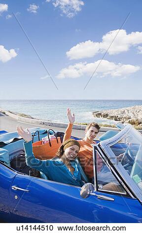 Man and woman in car by sea waving. View Large Photo Image Stock Image - Man and woman in car by sea waving.. Fotosearch
