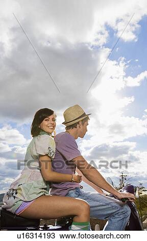 Man and woman on scooter. View Large Photo Image Stock Image - Man and woman on scooter.. Fotosearch