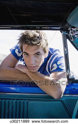 Man leaning into car. View Large Photo Image Stock Photo - Man leaning into car.. Fotosearch