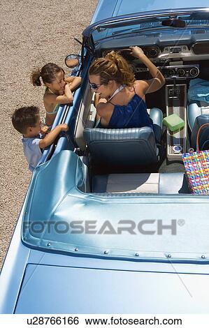 Mother and children by a car. View Large Photo Image Stock Photograph - Mother and children by a car.. Fotosearch