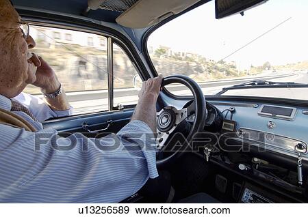 Senior man driving car along main road, side view, close-up View Large Photo Image Stock Photo - Senior man driving car along main road, side view, close-up. Fotosearch