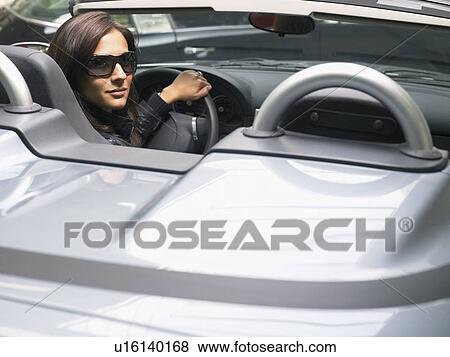 Women sitting in convertible looking behind. View Large Photo Image Stock Photo - Women sitting in convertible looking behind.. Fotosearch