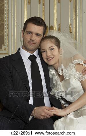 Stock Image - Bride and groom, smiling, portrait. Fotosearch