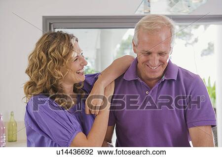 Stock Image - Man and woman in kitchen.. Fotosearch