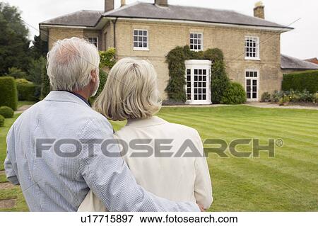 Senior couple admiring house. View Large Photo Image Stock Photo - Senior couple admiring house.. Fotosearch