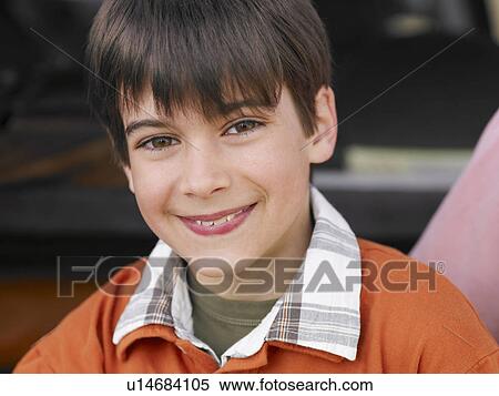 Stock Photography - Boy (8-10) with brown eyes and hair, smiling, close-up, portrait. Fotosearch