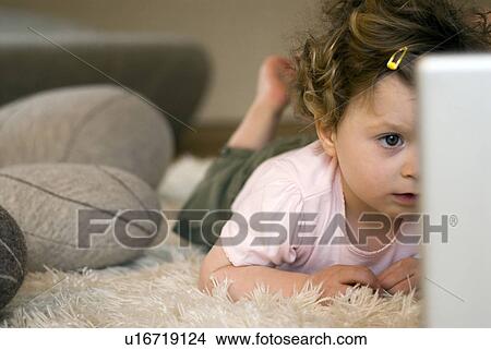Picture - Girl (9-12 months) using laptop.. Fotosearch