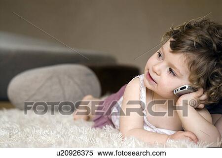 Girl (9-12 months) using mobile phone View Large Photo Image Stock Photography - Girl (9-12 months) using mobile phone. Fotosearch