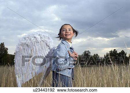 Girl wearing angel wings. View Large Photo Image Stock Image - Girl wearing angel wings.. Fotosearch