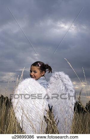 Girl wearing angel wings. View Large Photo Image Stock Photograph - Girl wearing angel wings.. Fotosearch