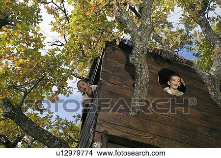 Picture - Kids playing in a tree house.. Fotosearch
