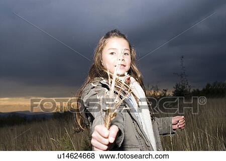 Portrait of a girl in a field. View Large Photo Image Stock Photo - Portrait of a girl in a field.. Fotosearch