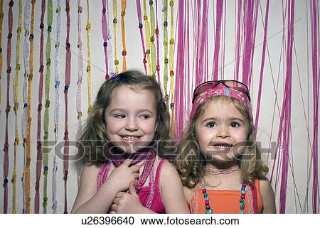 Stock Image - Two girls (2-4) dressed for a party.. Fotosearch