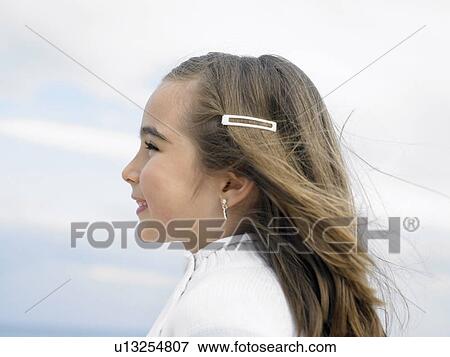Young girl (6-8) in the wind, profile, close-up. Alicante, Spain. View Large Photo Image Stock Photo - Young girl (6-8) in the wind, profile, close-up. Alicante, Spain.. Fotosearch