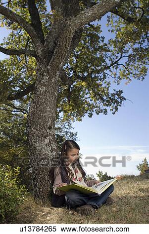 Young girl leaning against a tree. View Large Photo Image Stock Photography - Young girl leaning against a tree.. Fotosearch