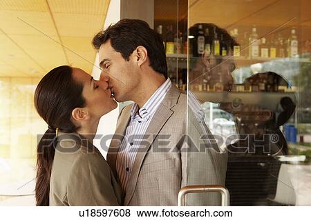 Stock Photo - A couple kissing in a doorway.. Fotosearch