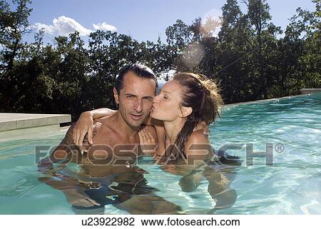Stock Image - Couple in a swimming pool. Fotosearch