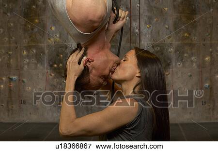 Couple kissing at indoor climbing centre View Large Photo Image Stock Photo - Couple kissing at indoor climbing centre. Fotosearch