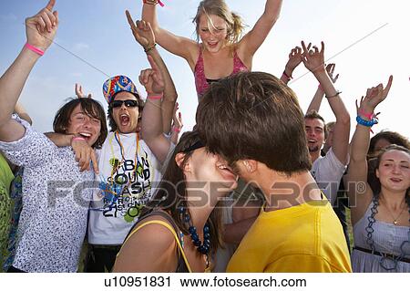 Couple kissing in front of crowd View Large Photo Image Stock Image - Couple kissing in front of crowd. Fotosearch