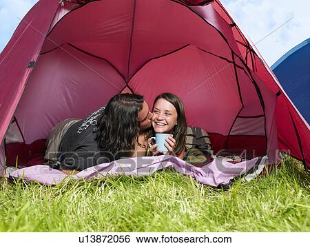 Couple kissing in pink tent View Large Photo Image Stock Photograph - Couple kissing in pink tent. Fotosearch