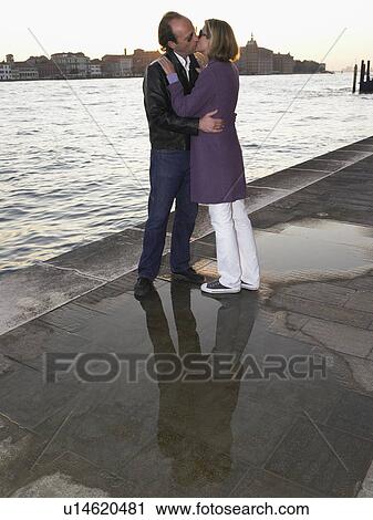 Couple kissing next to the sea View Large Photo Image Stock Image - Couple kissing next to the sea. Fotosearch