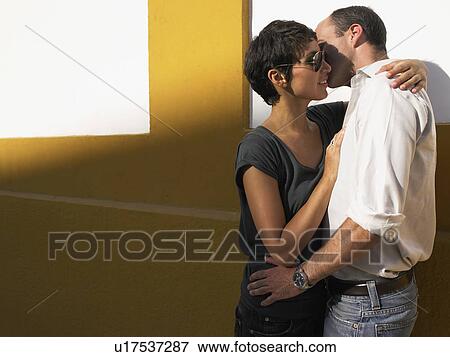 Couple kissing up against a wall. View Large Photo Image Stock Photo - Couple kissing up against a wall.. Fotosearch