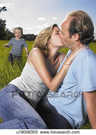 Mother and father kissing. View Large Photo Image Stock Image - Mother and father kissing.. Fotosearch