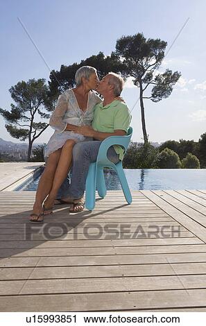 Older couple hugging on terrace. View Large Photo Image Stock Image - Older couple hugging on terrace.. Fotosearch