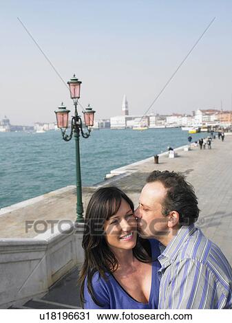 Portrait of kissing couple near lagoon. Venice, Italy. View Large Photo Image Stock Image - Portrait of kissing couple near lagoon. Venice, Italy.. Fotosearch