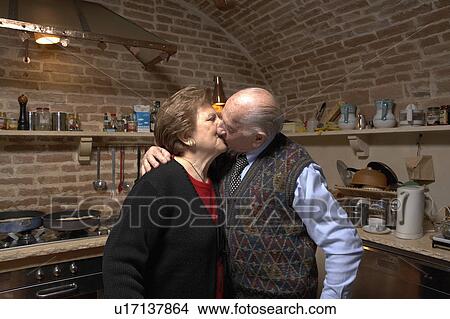 Senior couple in kitchen, kissing View Large Photo Image Picture - Senior couple in kitchen, kissing. Fotosearch