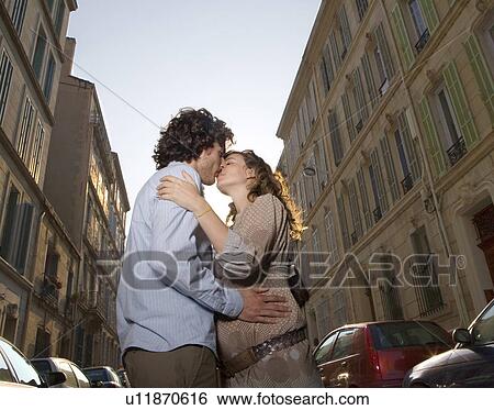 Young couple kissing in street View Large Photo Image Stock Photograph - Young couple kissing in street. Fotosearch