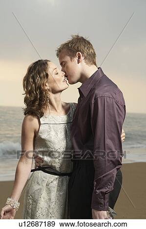 Stock Photo - Couple kissing on beach.. Fotosearch