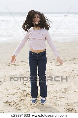 Girl jumping on beach. View Large Photo Image Stock Image - Girl jumping on beach.. Fotosearch