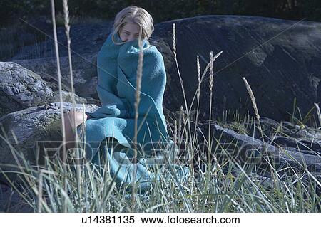 Stock Photography - Young Woman wrapped in blanket.. Fotosearch