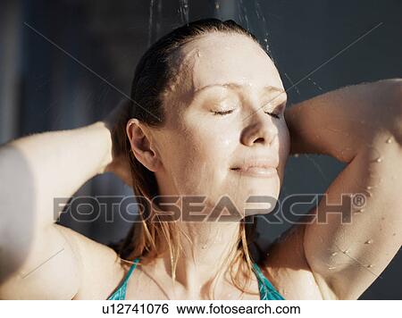 Woman beneath shower, eyes closed View Large Photo Image Stock Photograph - Woman beneath shower, eyes closed. Fotosearch